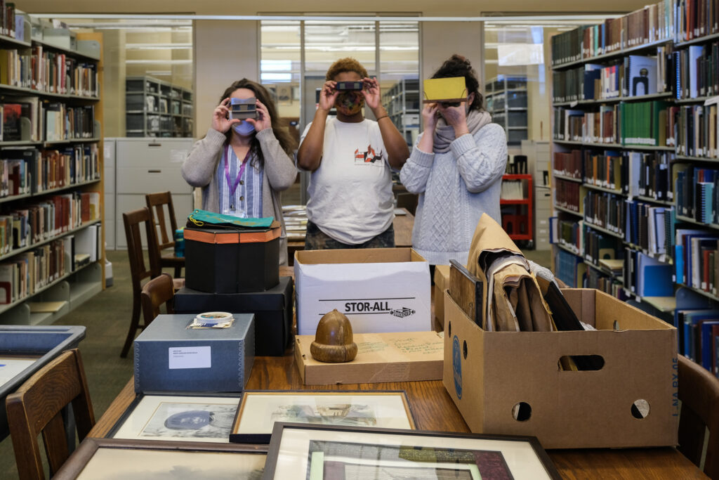 Katherine Cutshall, left, Honey Simone, center, and Lydia See at Buncombe County Special Collections. Photo by Lydia See
